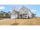 Charming two-story home with a two car garage, covered porch, and manicured lawn at 1129 Brookfield Dr, Gibsonville, NC 27249