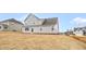 A two-story house with gray siding and a lawn in the backyard at 1129 Brookfield Dr, Gibsonville, NC 27249