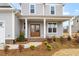 Charming front porch with a wooden double door, and landscaping at 1129 Brookfield Dr, Gibsonville, NC 27249