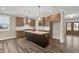 Kitchen boasts an island with bar seating, stainless appliances, and granite countertops at 1129 Brookfield Dr, Gibsonville, NC 27249