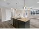 Kitchen features an island with seating, stainless appliances, and granite countertops at 1129 Brookfield Dr, Gibsonville, NC 27249