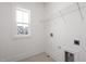 Bright laundry room with window and shelving at 192 Beacon Dr, Pittsboro, NC 27312