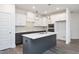 Modern kitchen with white and dark gray cabinets, quartz countertops, and island at 197 Beacon Dr, Pittsboro, NC 27312