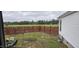 View of a fenced-in backyard offering privacy with a chair and patio furniture for outdoor relaxation at 3027 Nc Highway 210, Smithfield, NC 27577