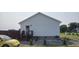 Home with a wooden fence, mature trees, and gravel landscaping at 3027 Nc Highway 210, Smithfield, NC 27577