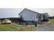 Exterior shot of a house with well-maintained landscaping, gravel features, and a car parked nearby at 3027 Nc Highway 210, Smithfield, NC 27577