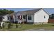 Charming home featuring a white exterior, well-maintained landscaping, and inviting curb appeal at 3027 Nc Highway 210, Smithfield, NC 27577