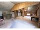 The unfinished basement offers exposed brick, a fireplace, and garage doors at 3095 Woodsdale Rd, Roxboro, NC 27574