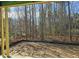 View of a lot's backyard under construction, surrounded by mature trees and landscaping at 3325 Colby Chase Dr # 9, Apex, NC 27539