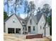 An exterior view of a two-story home showing an attached garage and a yard with trees at 3325 Colby Chase Dr # 9, Apex, NC 27539
