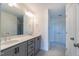 Double vanity bathroom with gray cabinets and a large mirror at 6104 Sunset Lake Rd, Fuquay Varina, NC 27526