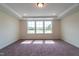 Bright bedroom with neutral carpeting and large windows at 6104 Sunset Lake Rd, Fuquay Varina, NC 27526