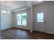 Bright dining room with hardwood floors and large windows at 6104 Sunset Lake Rd, Fuquay Varina, NC 27526