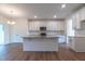 Modern kitchen boasting white cabinets and a large granite island at 6104 Sunset Lake Rd, Fuquay Varina, NC 27526