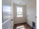Bright laundry room with wood-look floors and window at 6104 Sunset Lake Rd, Fuquay Varina, NC 27526