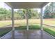 Screened porch with view of fenced backyard and trees at 6104 Sunset Lake Rd, Fuquay Varina, NC 27526