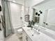 Bathroom with subway tile shower, quartz countertop, and decorative wall art at 2117 Opulent Oaks Ln # 15, Durham, NC 27713