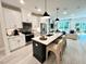 This open kitchen features a large island with seating, stainless appliances, and seamless transition to living area at 2117 Opulent Oaks Ln # 15, Durham, NC 27713