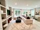 Bright living room features a comfortable sectional sofa, modern rug, and open access to outdoor views at 2117 Opulent Oaks Ln # 15, Durham, NC 27713