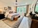 Well-lit main bedroom features a decorative rug, stylish furniture, and serene views at 2117 Opulent Oaks Ln # 15, Durham, NC 27713