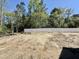 Spacious, level backyard bordered by a white fence and mature trees, offering privacy at 2613 Silver Gate Ct, Wake Forest, NC 27587