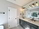 Bathroom featuring double sinks, modern fixtures, and a large mirror at 2613 Silver Gate Ct, Wake Forest, NC 27587