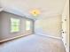 Bright bedroom with neutral walls, carpet, and natural light from two windows at 2613 Silver Gate Ct, Wake Forest, NC 27587