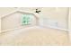 Spacious bonus room with a ceiling fan, large window, and plush carpeting at 2613 Silver Gate Ct, Wake Forest, NC 27587