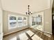 Cozy dining area with modern lighting, hardwood floors, and sliding door access to outdoor patio at 2613 Silver Gate Ct, Wake Forest, NC 27587