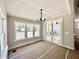 Bright dining room features an elegant chandelier, large windows, and sliding door access to outdoor space at 2613 Silver Gate Ct, Wake Forest, NC 27587