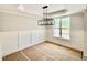 Unfinished dining room features a large window, modern light fixture, and classic wall trim at 2613 Silver Gate Ct, Wake Forest, NC 27587