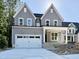 Charming two-story home with gray siding, white trim, a two-car garage, and a welcoming front porch at 2613 Silver Gate Ct, Wake Forest, NC 27587