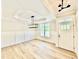 Elegant foyer with wainscoting, modern lighting, a tray ceiling, and light wood-look floors at 2613 Silver Gate Ct, Wake Forest, NC 27587