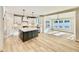 Spacious kitchen with island, stainless appliances, white cabinets, and modern finishes at 2613 Silver Gate Ct, Wake Forest, NC 27587