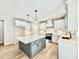 Bright kitchen features an island, stainless appliances, white cabinets, and hardwood floors at 2613 Silver Gate Ct, Wake Forest, NC 27587