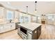 Modern kitchen featuring an island, stainless appliances, white cabinets, and open layout to living room at 2613 Silver Gate Ct, Wake Forest, NC 27587