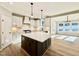 Open kitchen with island, stainless steel appliances, white cabinets, and view into dining area at 2613 Silver Gate Ct, Wake Forest, NC 27587