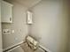 Bright laundry room with white cabinets and hookups at 2613 Silver Gate Ct, Wake Forest, NC 27587