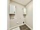 Practical laundry room features tile flooring and sleek, white cabinetry at 2613 Silver Gate Ct, Wake Forest, NC 27587