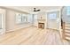 Bright living room with hardwood floors, a ceiling fan, large windows, and a decorative fireplace at 2613 Silver Gate Ct, Wake Forest, NC 27587