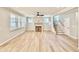Inviting living room with fireplace, large windows, hardwood floors, and access to staircase at 2613 Silver Gate Ct, Wake Forest, NC 27587