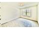 Clean bedroom with a single window providing natural light and fresh, neutral-toned walls at 2617 Silver Gate Ct, Wake Forest, NC 27587