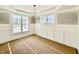 Bright dining room with wainscoting, chandelier and large windows at 2617 Silver Gate Ct, Wake Forest, NC 27587