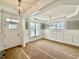 Bright dining room with coffered ceilings, wainscoting, chandelier and large windows at 2617 Silver Gate Ct, Wake Forest, NC 27587