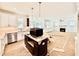 Modern kitchen with white cabinets, stainless steel appliances, and a black island at 2617 Silver Gate Ct, Wake Forest, NC 27587