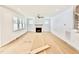 Bright living room featuring a fireplace, large windows, and modern ceiling fan at 2617 Silver Gate Ct, Wake Forest, NC 27587