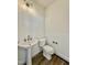 Compact powder room featuring a pedestal sink, a modern faucet, and a water closet at 2617 Silver Gate Ct, Wake Forest, NC 27587