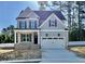 Charming two-story home with gray siding, black shutters, covered porch, and a two-car garage at 2621 Silver Gate Ct, Wake Forest, NC 27587