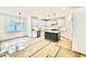 Open kitchen with white cabinets, stainless steel appliances, kitchen island and bright lighting at 2621 Silver Gate Ct, Wake Forest, NC 27587