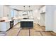 Open kitchen with white cabinets, stainless steel appliances, kitchen island and modern countertops at 2621 Silver Gate Ct, Wake Forest, NC 27587